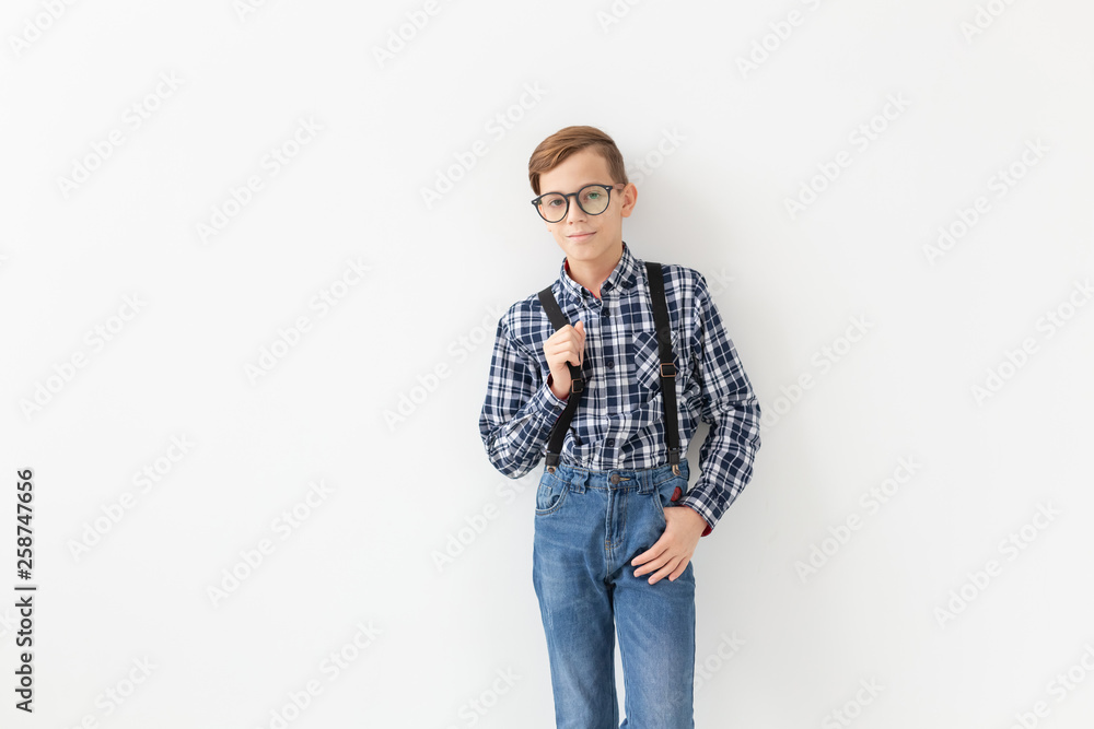 Style, children and family concept - cute teen boy posing on white background Style, children and family concept - cute teen boy posing on white background