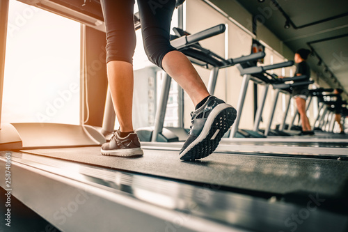 Close up on shoe,Women running in a gym on a treadmill.exercising concept.fitness and healthy lifestyle