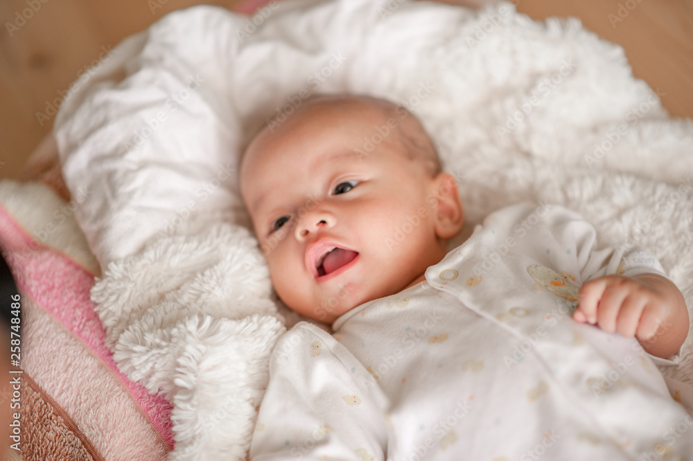 Cute baby boy in a white light bedroom Newborn baby is cute. In bedding for children born - images