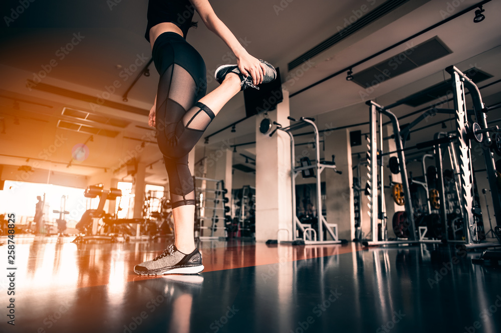 Fototapeta premium Relaxing after training.beautiful young woman looking away while sitting at gym.young female at gym taking a break from workout.