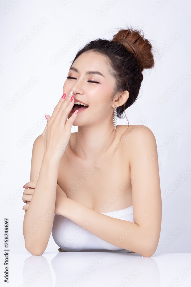 Portrait of attractive asian woman sitting smiling on white background. Healthy skin woman natural makeup beauty face concept. Using as your Product. Portrait of attractive asian woman sitting smiling on white background. Healthy skin woman natural makeup beauty face concept. Using as your Product.