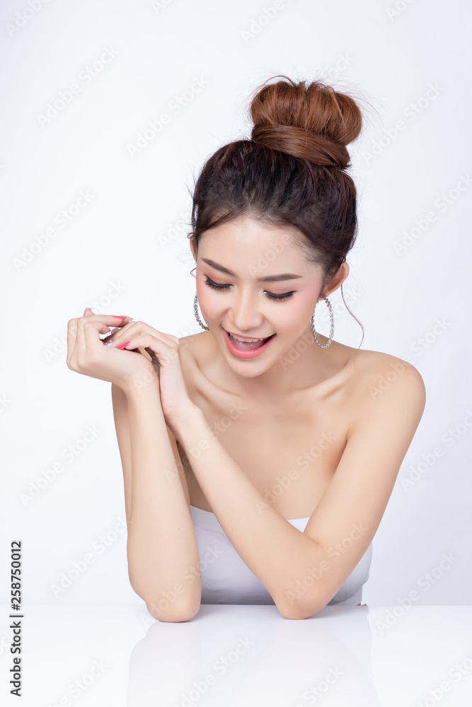 Portrait of attractive asian woman sitting smiling on white background. Healthy skin woman natural makeup beauty face concept. Using as your Product. Portrait of attractive asian woman sitting smiling on white background. Healthy skin woman natural makeup beauty face concept. Using as your Product.