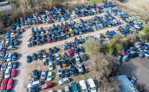 Lines of crushed cars wreck in scrapyard before being shredded recyling photo