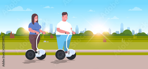 overweight couple riding self balancing scooter city park obese man woman on electric gyroscooter weight loss concept full length outdoor landscape background horizontal