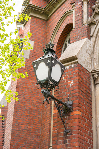 Old lantern on the wall of St. John's Church, Helsinki, Finland photo