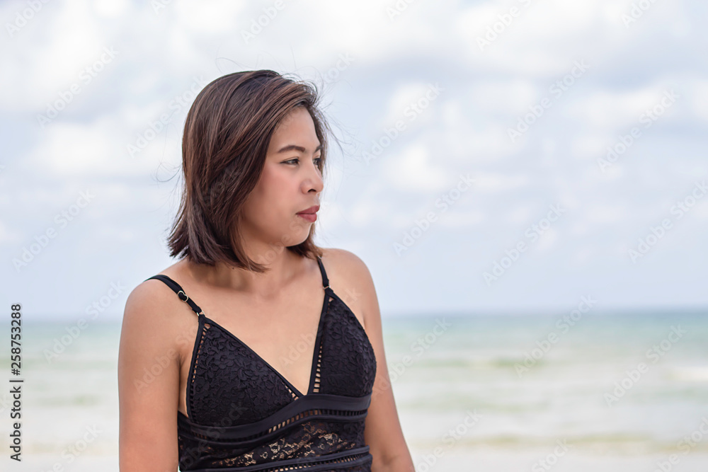 Portrait of Asian woman wearing a swimsuit background sea and sky Portrait of Asian woman wearing a swimsuit background sea and sky