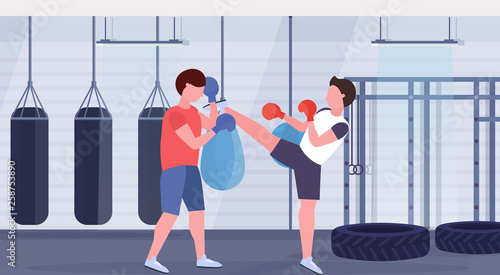 two boxers training kick boxing exercises fighters in gloves practicing together modern fight club with punching bags healthy lifestyle concept flat horizontal full length