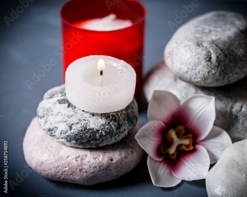 Flowers  burning candle and stone for spa. Spa composition