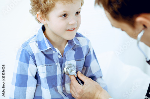 Doctor and patient child. Physician examining little boy. Regular medical visit in clinic. Medicine and health care concept