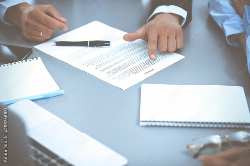 Group of business people at meeting discussing contract Group of business people at meeting discussing contract