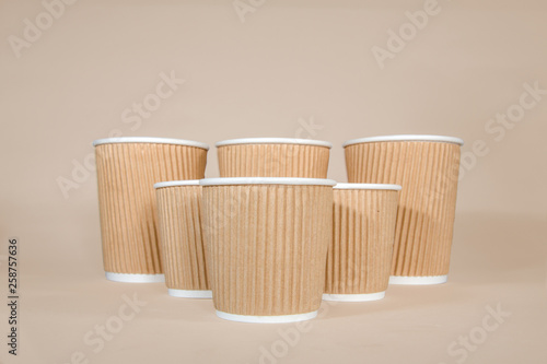 Disposable coffee cups on a brown background