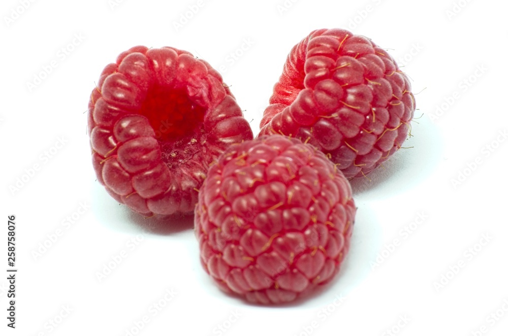 Raspberries over white background