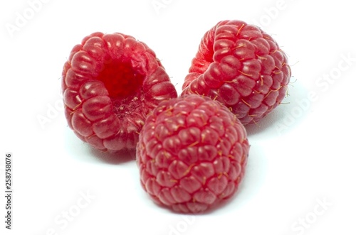 Raspberries over white background
