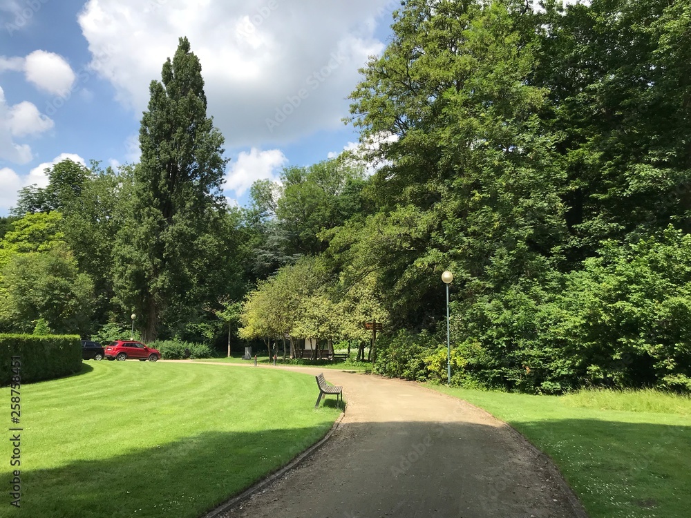 Route en gravier paisible traversant une pelouse au long de la végétation luxuriante du domaine provincial de Vrijbroekpark à Malines