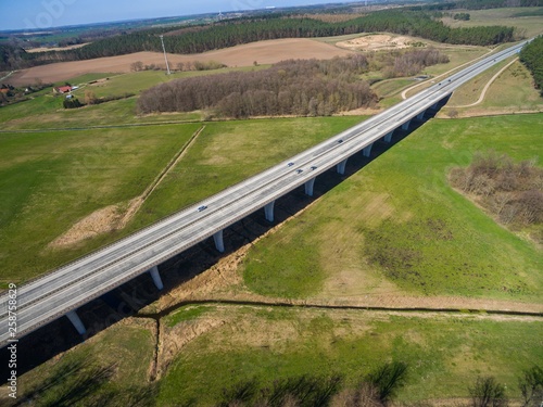 highway bridge in rural area - aerial view of a big highway bridge in rural area in germany european - cars drive over the highway bridge - drone flight