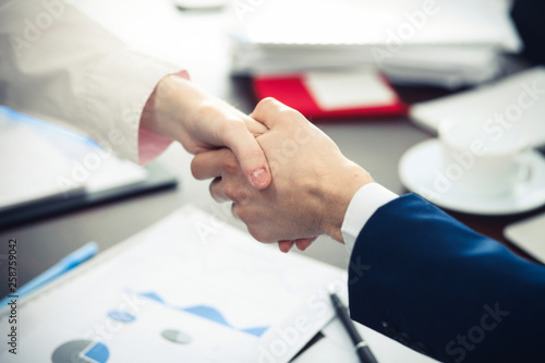 Business people shaking hands finishing up a meeting. Handshake at successful negotiation