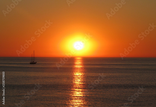 Ship on the background of the sunset on the sea. © Payllik