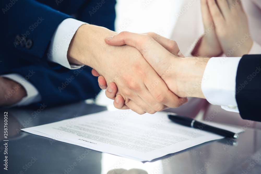 Business people shaking hands finishing up a meeting. Handshake at successful negotiation Business people shaking hands finishing up a meeting. Handshake at successful negotiation
