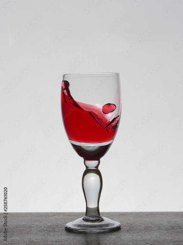 Spray liquid (clear water, red wine) from a glass goblet. Spray liquid (clear water, red wine) from a glass goblet.