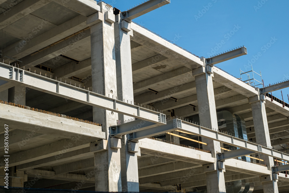 concrete bulding in construction and yellow crane concrete bulding in construction and yellow crane
