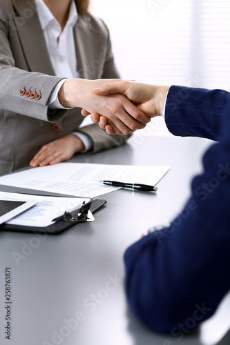 Business people shaking hands, finishing up a meeting. Papers signing, agreement and lawyer consulting concept © rogerphoto