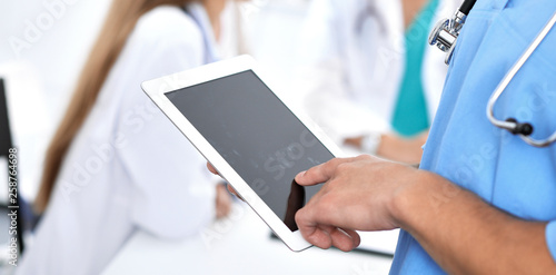Wallpaper Mural Surgeon doctor using tablet computer, close-up of hands at touch pad screen Torontodigital.ca