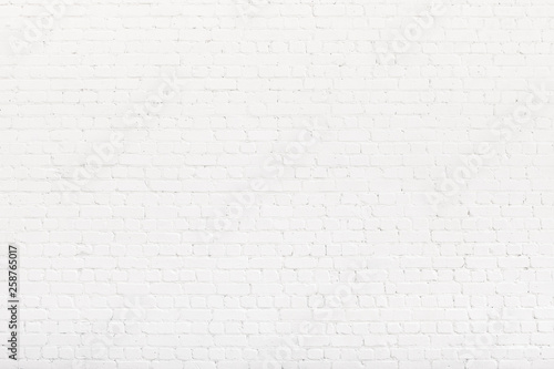 Brick wall painted with white paint. White Loft background, texture