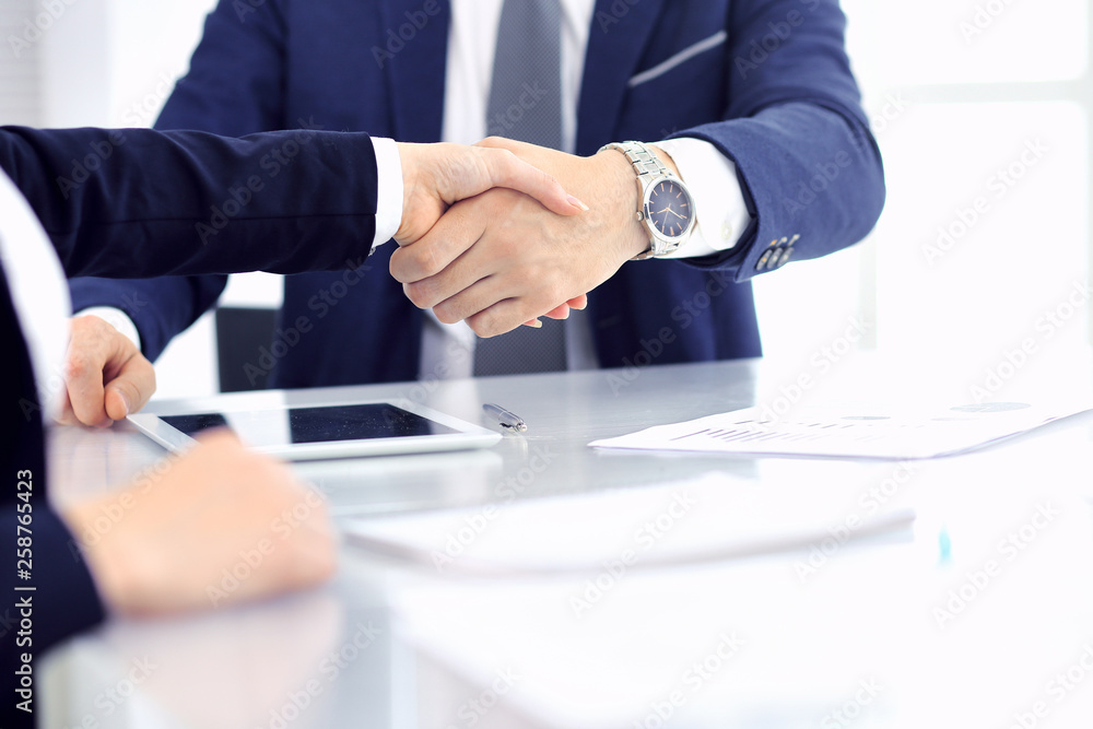 Group of business people or lawyers shaking hands finishing up a meeting , close-up. Success at negotiation and handshake concepts Group of business people or lawyers shaking hands finishing up a meeting , close-up. Success at negotiation and handshake concepts