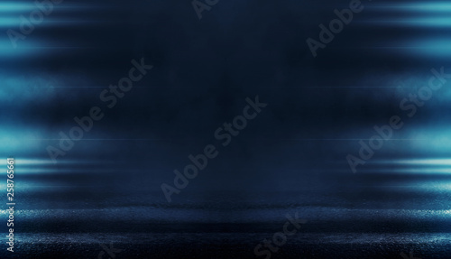 Background of empty dark room with rays of light. Concrete floor with light reflection. Smoke, neon blue light