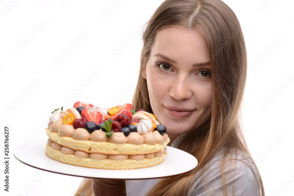 baker girl with a cake with berries on a white background baker girl with a cake with berries on a white background