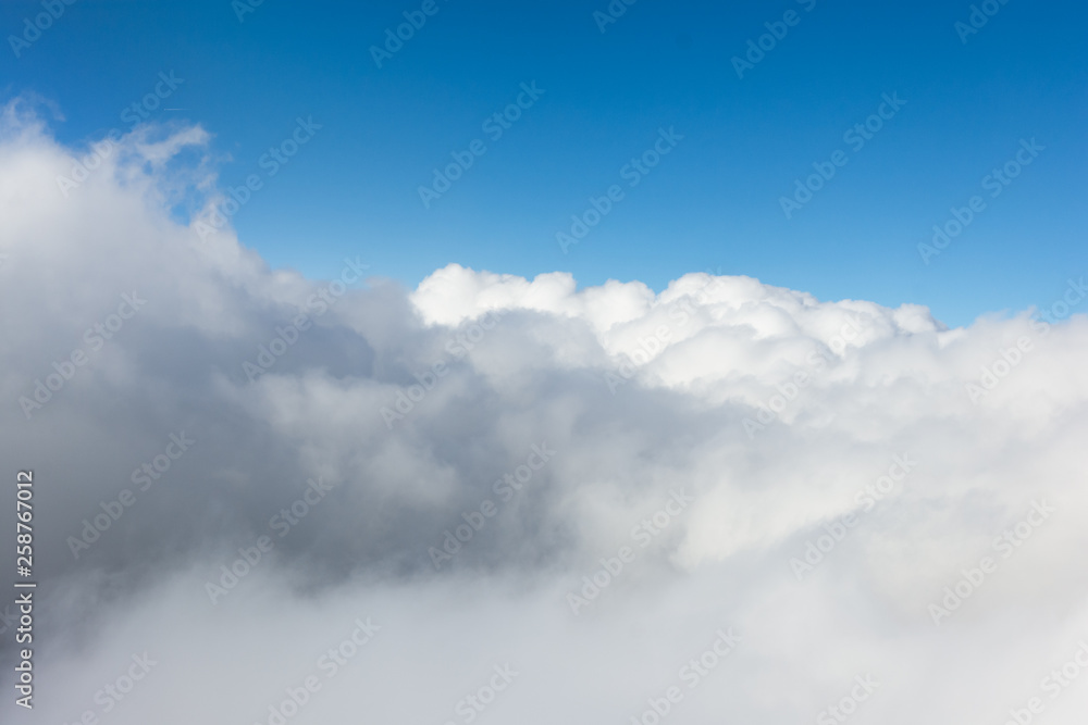 Impressive cloudscape with white clouds beneath Impressive cloudscape with white clouds beneath