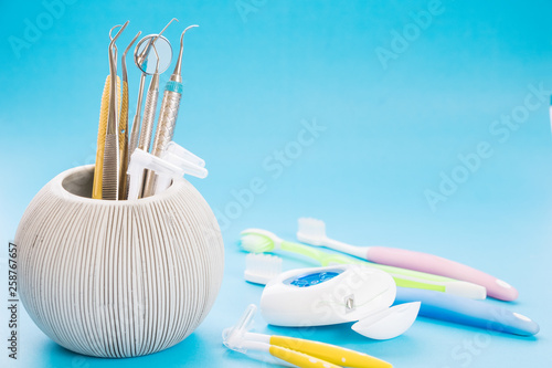 Dental tools use for dentist in the office or clinic. On the blue background. photo