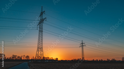 Beautiful sunset with powerlines near Tabertshausen-Bavaria-Germany photo