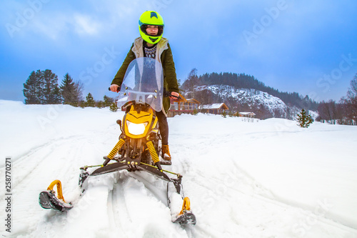 Girl rides a snowmobile. Fu...