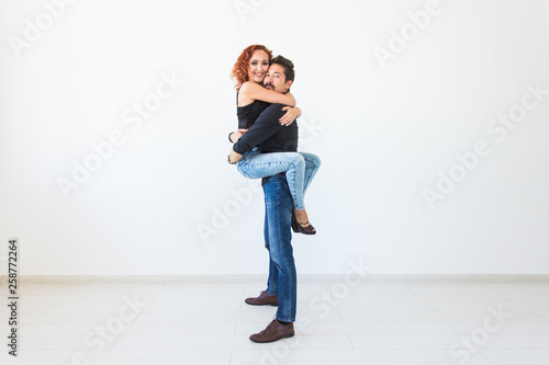 Romantic, passion, people concept - young couple dancing with passion on white background with copy space