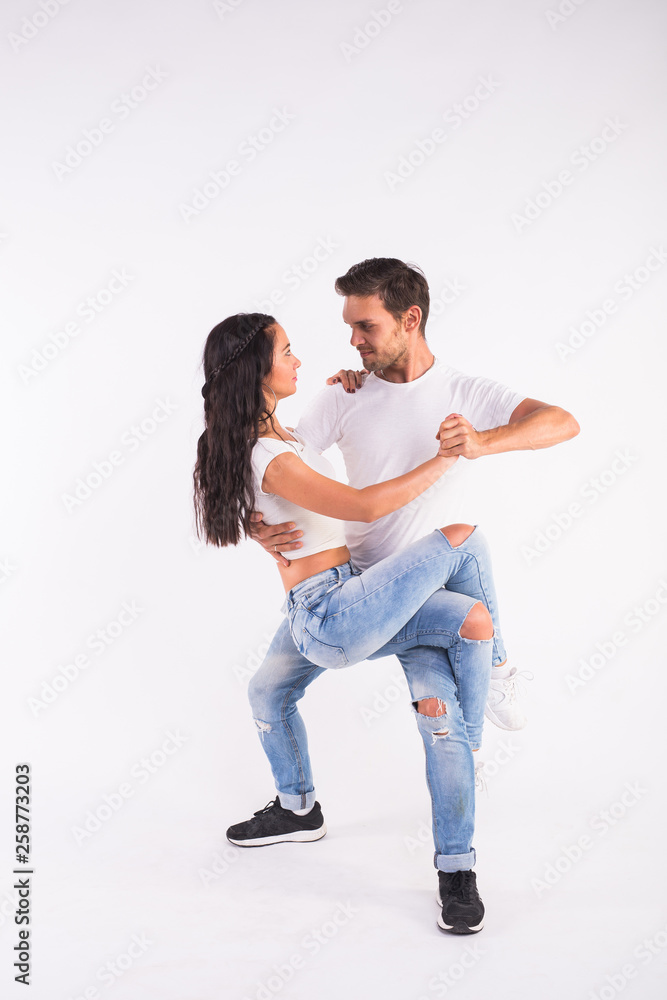Young couple dancing social latin dance bachata, merengue, salsa. Two  elegance pose on white background Stock Photo | Adobe Stock