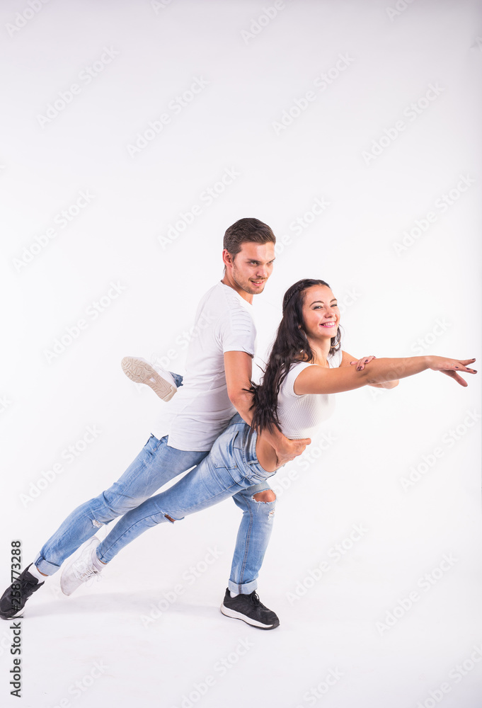 Young couple dancing social latin dance bachata, merengue, salsa. Two elegance pose on white background Young couple dancing social latin dance bachata, merengue, salsa. Two elegance pose on white background
