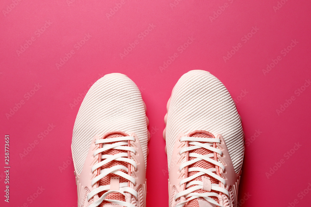 women's sneakers on a colored background top view. Women's shoes