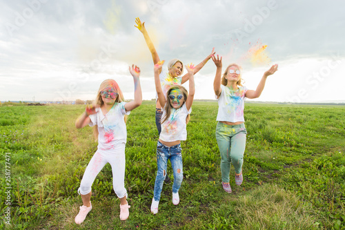 Family, festival of holi and holidays concept - portrait of happy family covered in paint