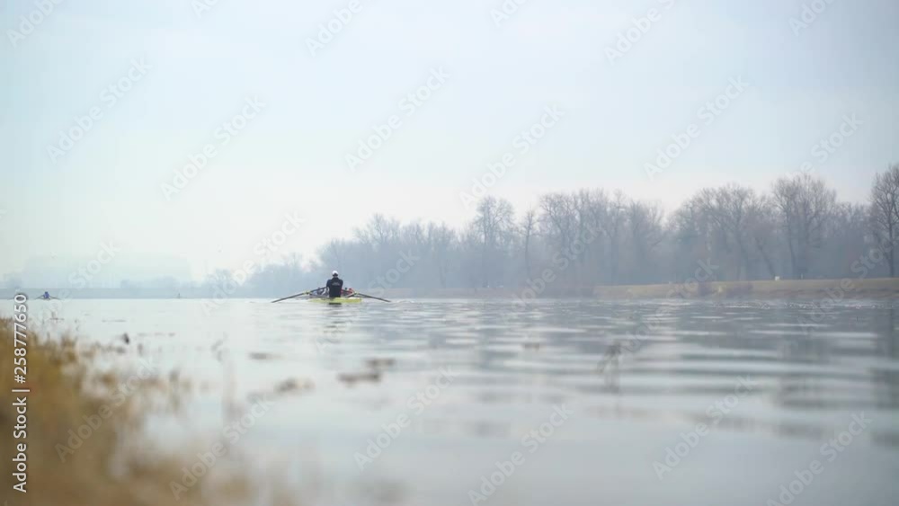 Image of man rowing alone at an artificial lake, Zagreb, Croatia.