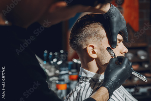 Man with a beard. Hairdresser with a client.