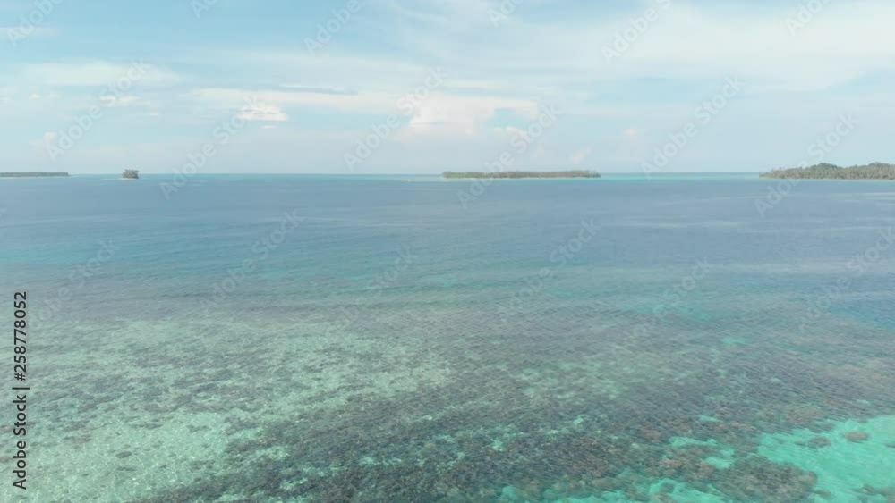 Aerial: flying over desert island tropical beach caribbean sea turquoise water coral reef. Indonesia Sumatra Banyak islands. tourist destination diving snorkeling. Native cinelike D-log color profile. Aerial: flying over desert island tropical beach caribbean sea turquoise water coral reef. Indonesia Sumatra Banyak islands. tourist destination diving snorkeling. Native cinelike D-log color profile.
