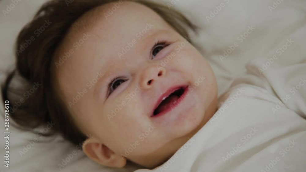 Beautiful little girl woke up and smiles at the camera Beautiful little girl woke up and smiles at the camera