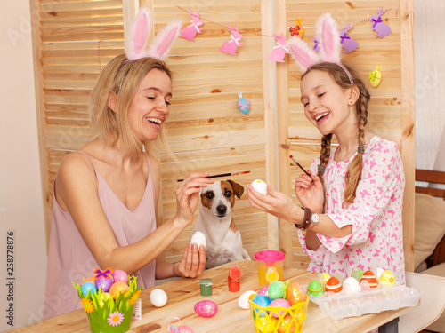 Wall Mural Happy woman with child paint easter eggs