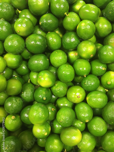 heap of raw green limes fruits pattern