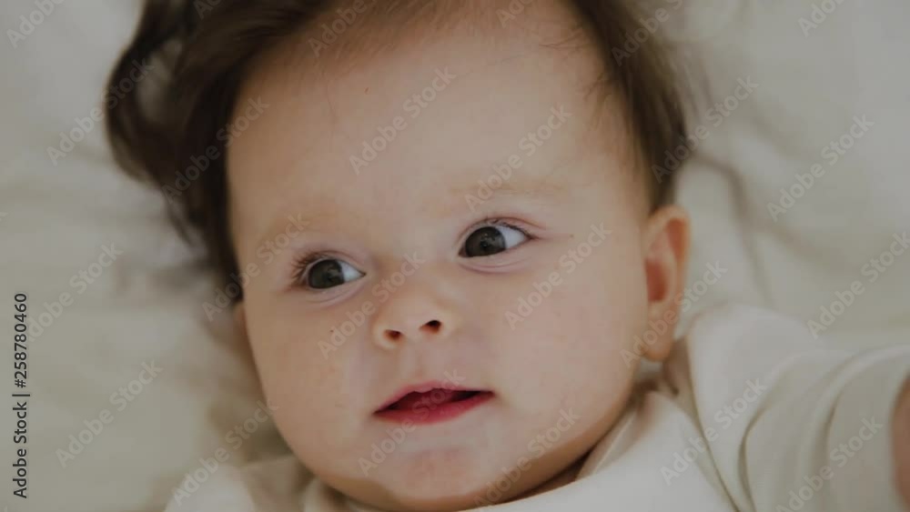 Beautiful little girl woke up and smiles at the camera Beautiful little girl woke up and smiles at the camera