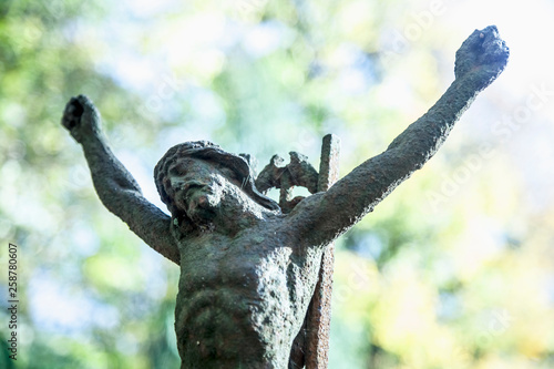 Destroyed ancient iron statue of the crucifixion of Jesus Christ as a symbol of human soul eternal life. © zwiebackesser