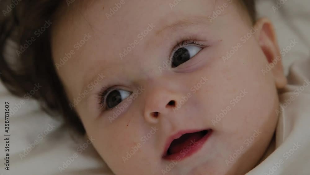 Beautiful little girl woke up and smiles at the camera Beautiful little girl woke up and smiles at the camera