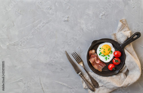 Fried egg with bacon and cherry tomatoes
