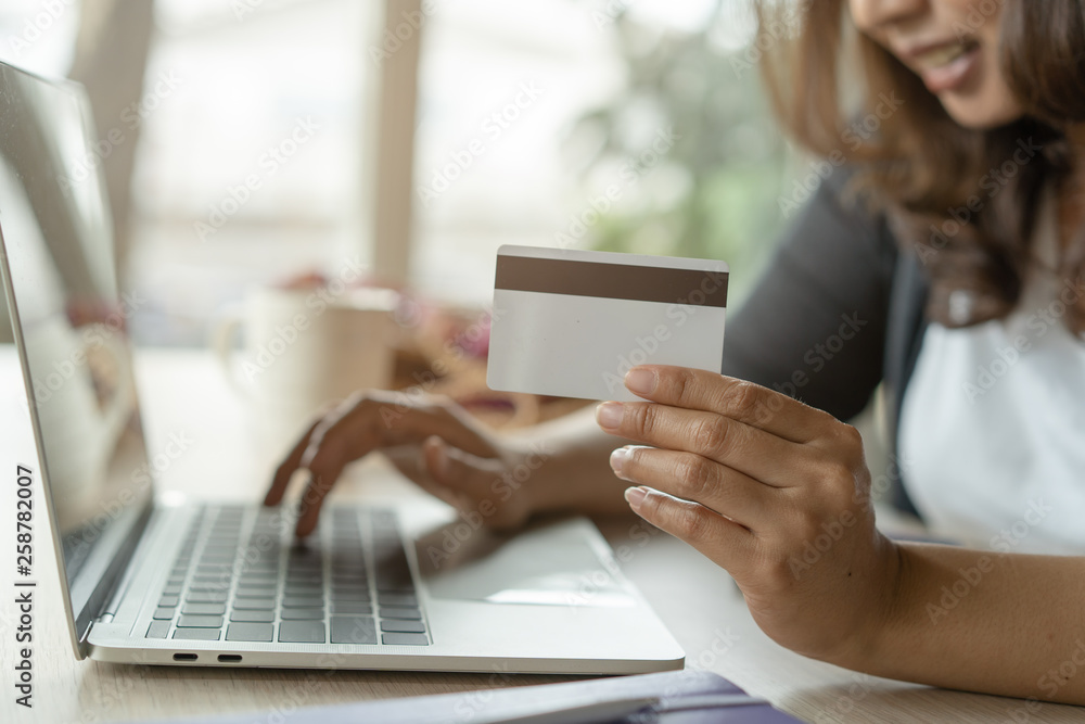 close up shots hands of person shopping on ecommerce and using credit card payment via online banking. close up shots hands of person shopping on ecommerce and using credit card payment via online banking.
